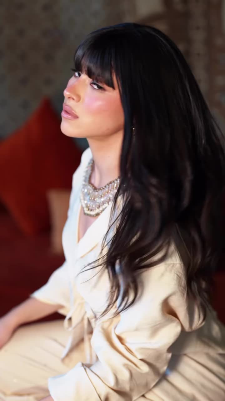 A model in a gown inside an ornate interior