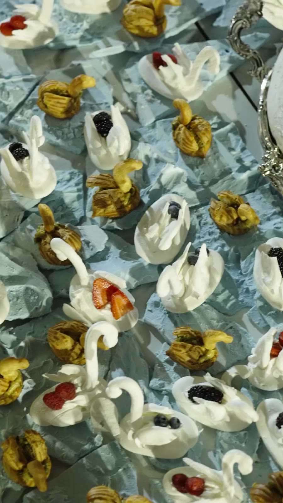 Swan-shaped patisserie pieces plated on ice