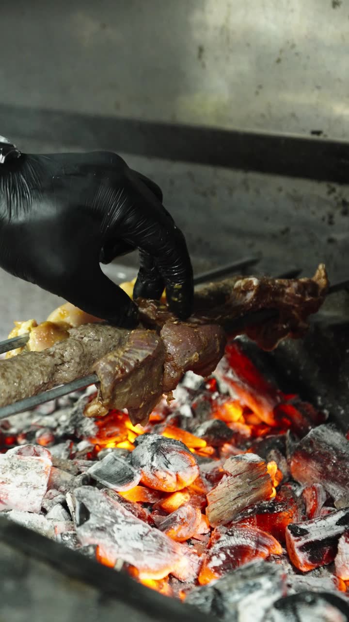 Kebab skewers over glowing charcoal