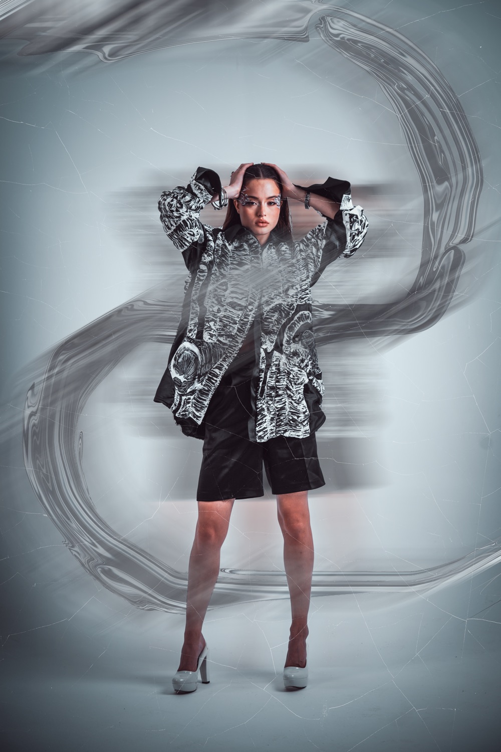 A model against a painted swirl backdrop