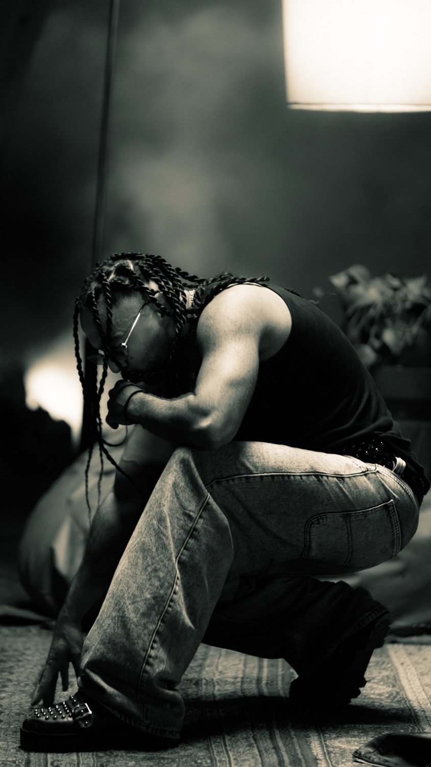 A dramatic crouched figure in black and white